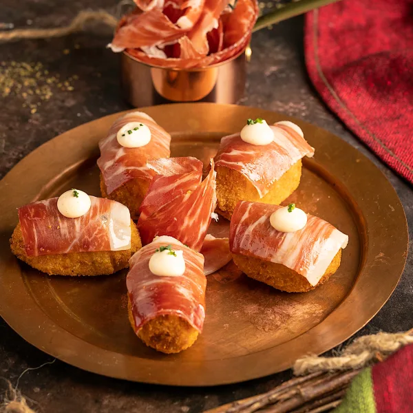 Eating view of croquettes with ham and Kimchi and cilantro mayonnaise.