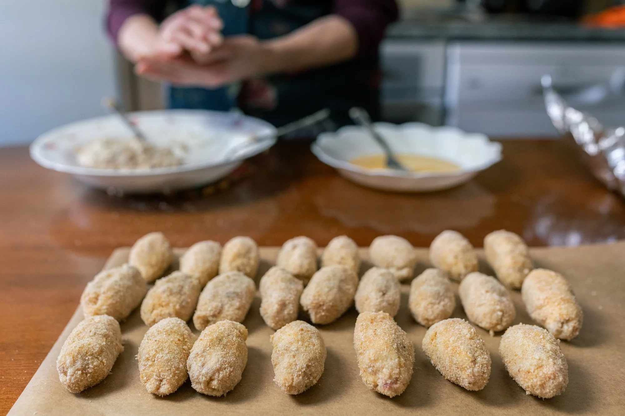 Many croquettes lined up and ready to fry